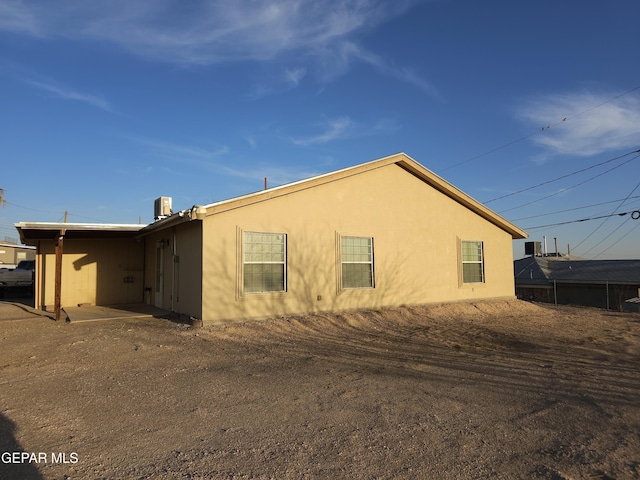 view of side of home featuring stucco siding