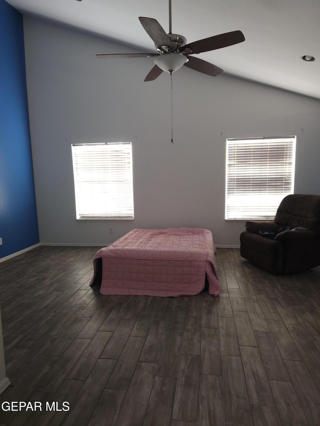 bedroom with a ceiling fan, lofted ceiling, wood finished floors, and baseboards