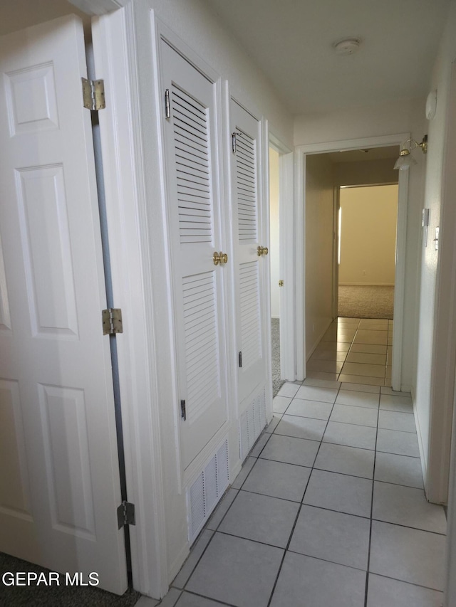 corridor with light tile patterned floors and visible vents