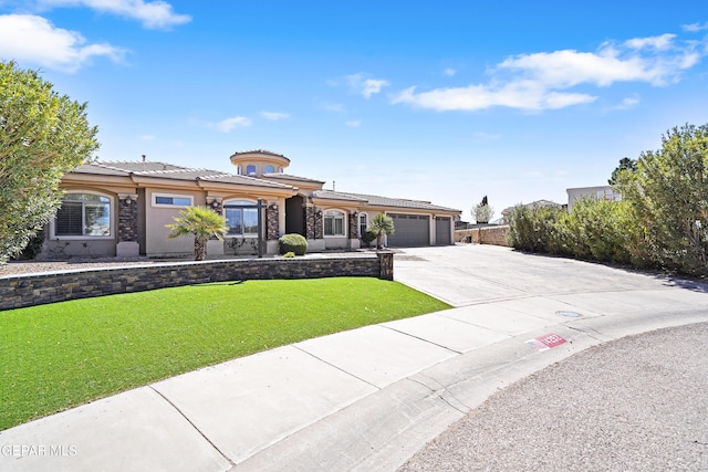 view of front of home featuring a front lawn, a tile roof, stucco siding, a garage, and driveway