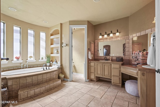 full bath featuring tile patterned floors, vanity, and a garden tub