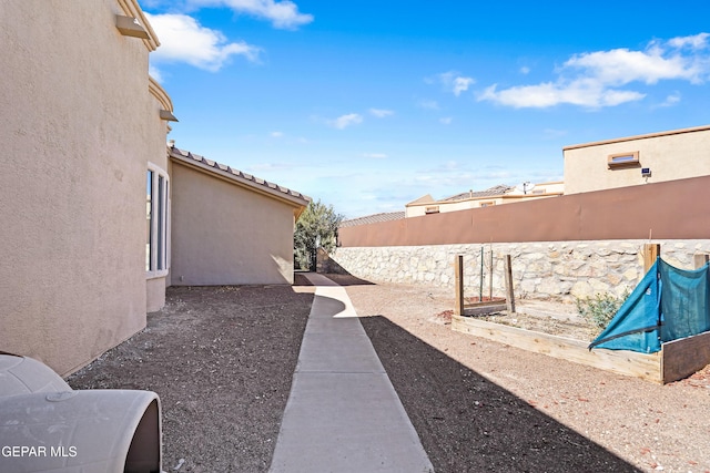 view of yard featuring a vegetable garden and fence