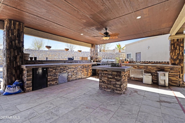 view of patio with grilling area, area for grilling, ceiling fan, and fence