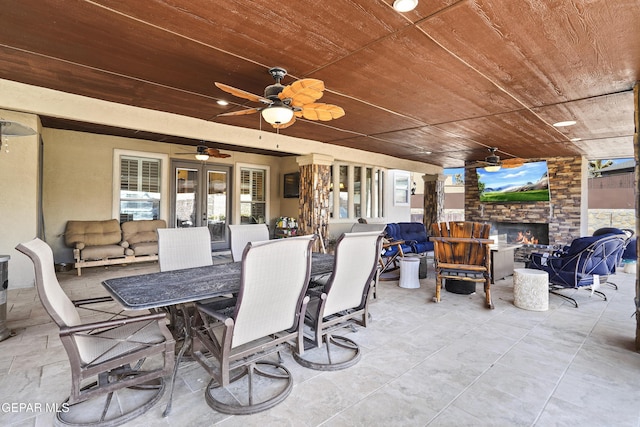 view of patio featuring an outdoor living space, outdoor dining area, a ceiling fan, and french doors