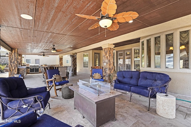 view of patio with french doors, an outdoor living space with a fire pit, and ceiling fan