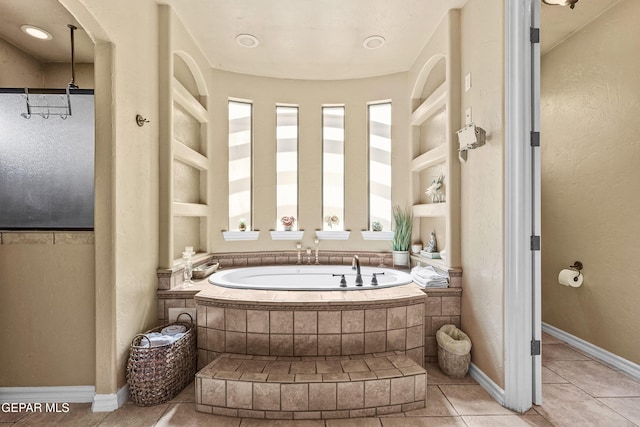 full bath with a bath, built in features, tile patterned floors, and baseboards