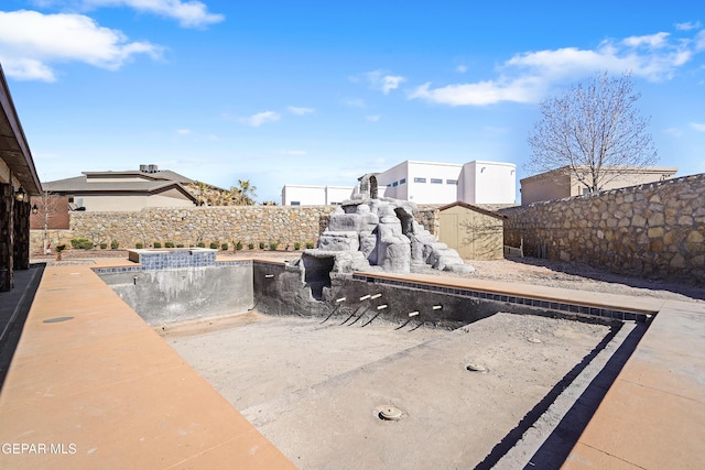 view of patio / terrace with an outbuilding, a shed, and a fenced backyard