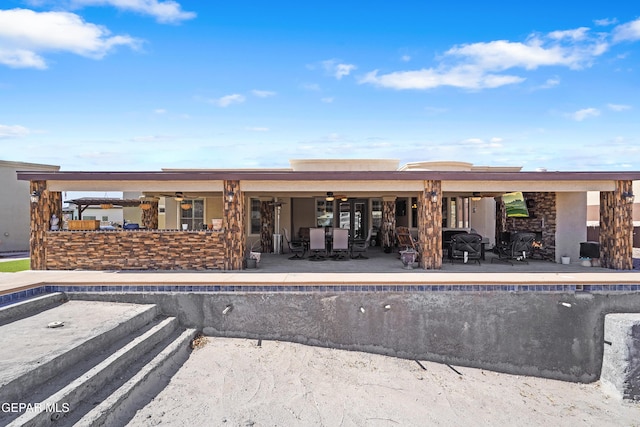 rear view of property featuring an empty pool, ceiling fan, outdoor dining space, and a patio area