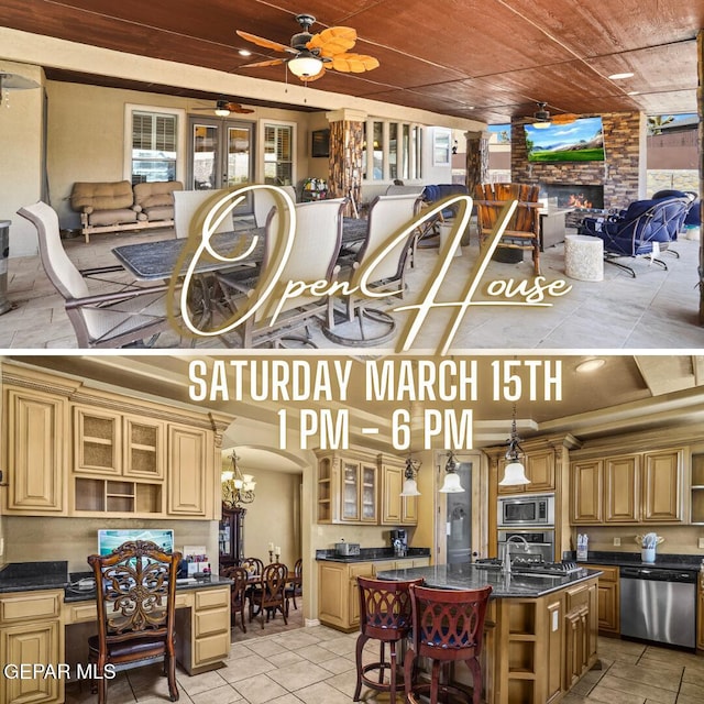 kitchen featuring a breakfast bar area, open shelves, a fireplace, appliances with stainless steel finishes, and open floor plan