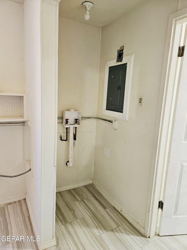 washroom featuring electric panel, laundry area, hookup for a washing machine, and baseboards