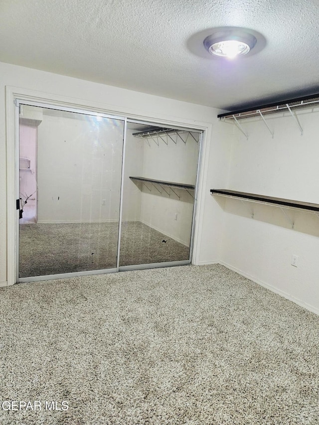 walk in closet with carpet