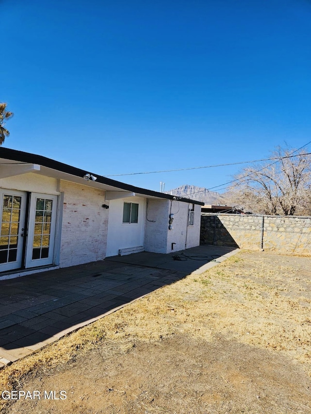 exterior space featuring french doors and fence