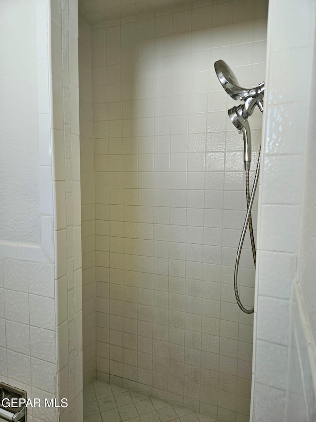 interior details featuring a tile shower