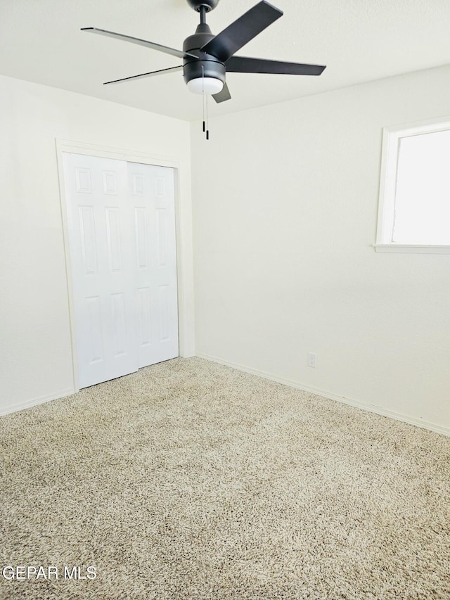 unfurnished bedroom with a closet and ceiling fan