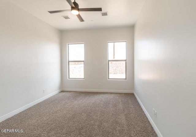 carpeted empty room featuring visible vents, baseboards, and ceiling fan