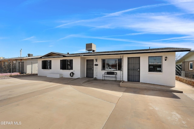 view of front of home featuring a patio area and fence