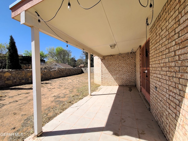 view of patio featuring fence