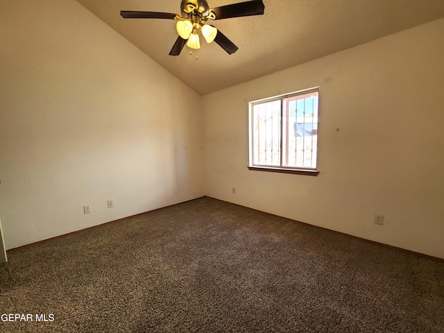 unfurnished room with dark carpet, a textured ceiling, a ceiling fan, and vaulted ceiling