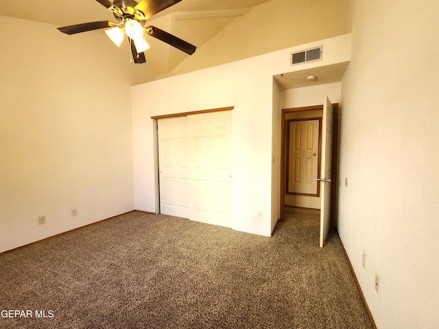 unfurnished bedroom featuring visible vents, ceiling fan, lofted ceiling, carpet flooring, and a closet