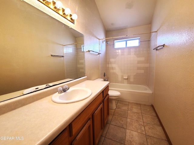 bathroom featuring toilet, shower / bathing tub combination, tile patterned flooring, baseboards, and vanity