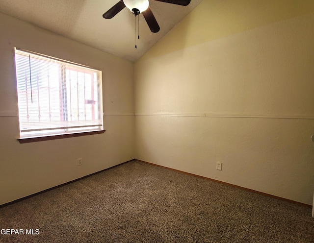 unfurnished room with baseboards, lofted ceiling, and a ceiling fan