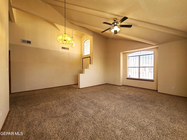 empty room featuring lofted ceiling with beams, visible vents, a textured ceiling, and carpet flooring