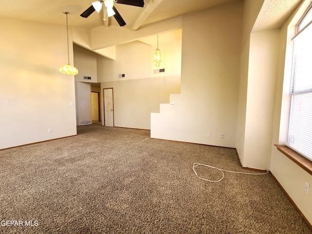 carpeted spare room featuring high vaulted ceiling, visible vents, and ceiling fan