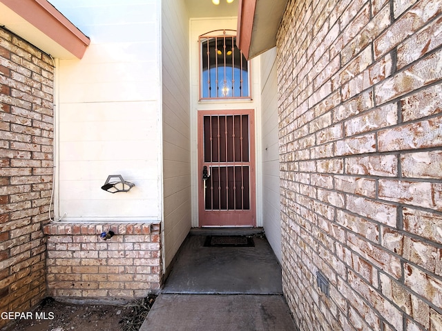 entrance to property with brick siding