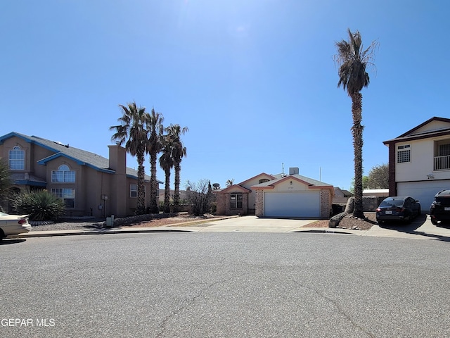 view of front of property with concrete driveway and a garage