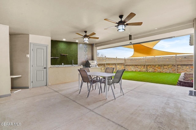 view of patio with ceiling fan, outdoor dining space, and fence