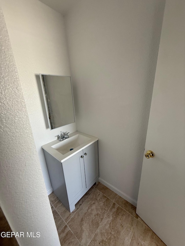 bathroom featuring vanity and baseboards