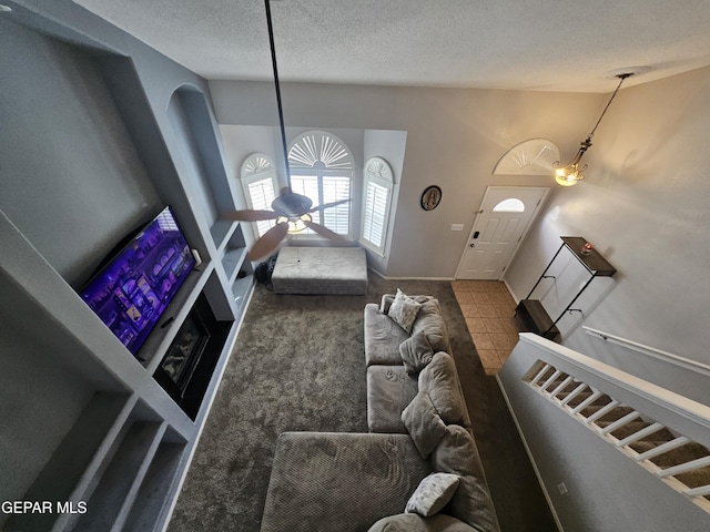 living area with a textured ceiling and carpet floors