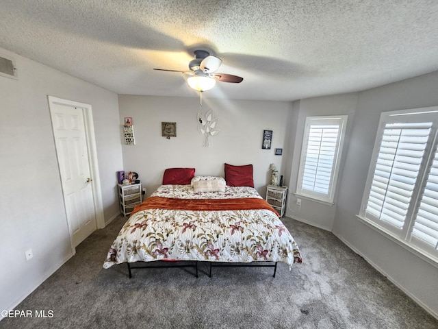 carpeted bedroom with a textured ceiling and ceiling fan