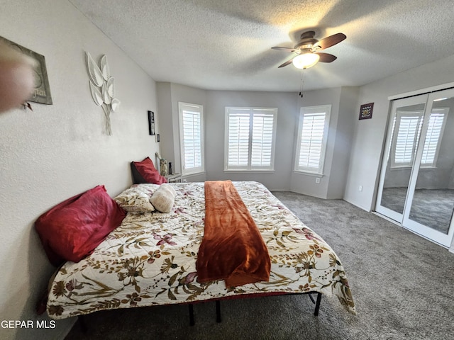 carpeted bedroom featuring a textured ceiling, a ceiling fan, and access to outside