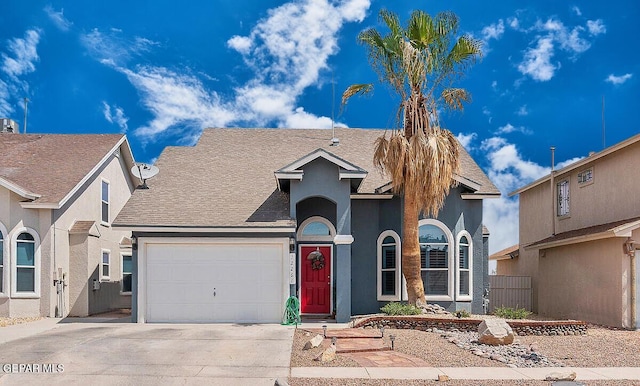 view of front of property featuring stucco siding, fence, roof with shingles, concrete driveway, and an attached garage