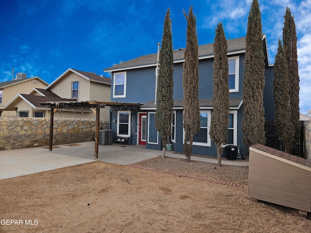 view of front of home featuring fence, central air condition unit, stucco siding, a patio area, and a pergola