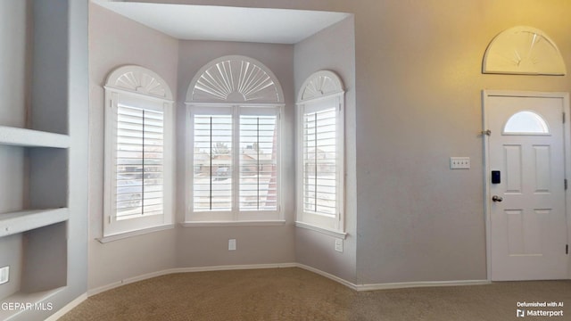 entryway with carpet flooring and baseboards