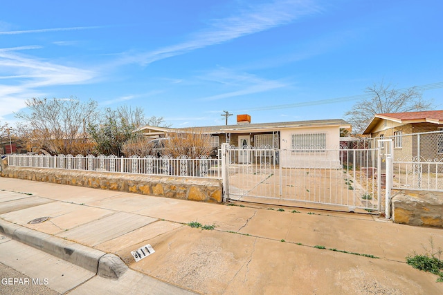 single story home featuring a fenced front yard and a gate