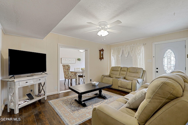 living area featuring dark wood-style floors, a textured ceiling, and ceiling fan