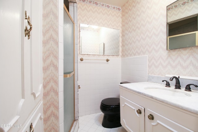 full bathroom featuring vanity, wallpapered walls, a shower stall, tile patterned floors, and toilet