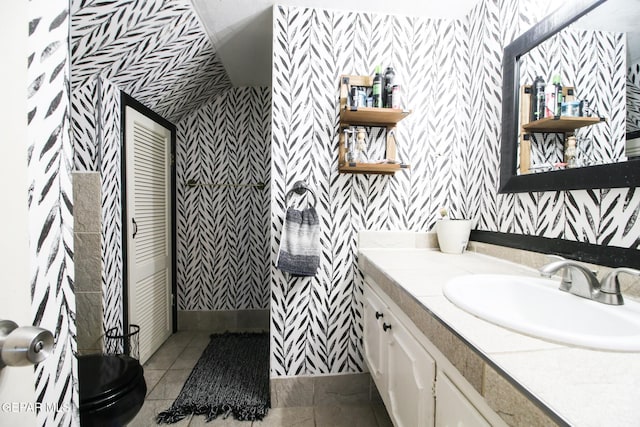 bathroom featuring wallpapered walls, tile patterned floors, and vanity