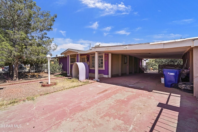 manufactured / mobile home featuring an attached carport and concrete driveway