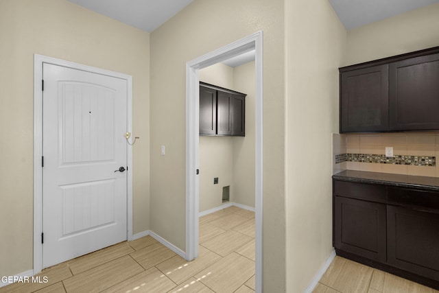 interior space featuring wood finish floors, cabinet space, and baseboards