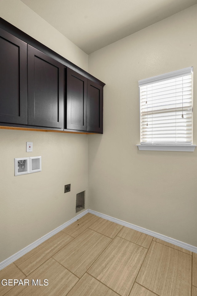 washroom featuring light wood-style flooring, cabinet space, baseboards, hookup for an electric dryer, and hookup for a washing machine