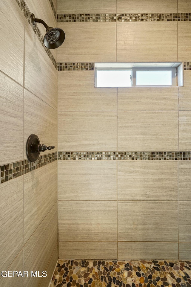 full bath featuring tiled shower