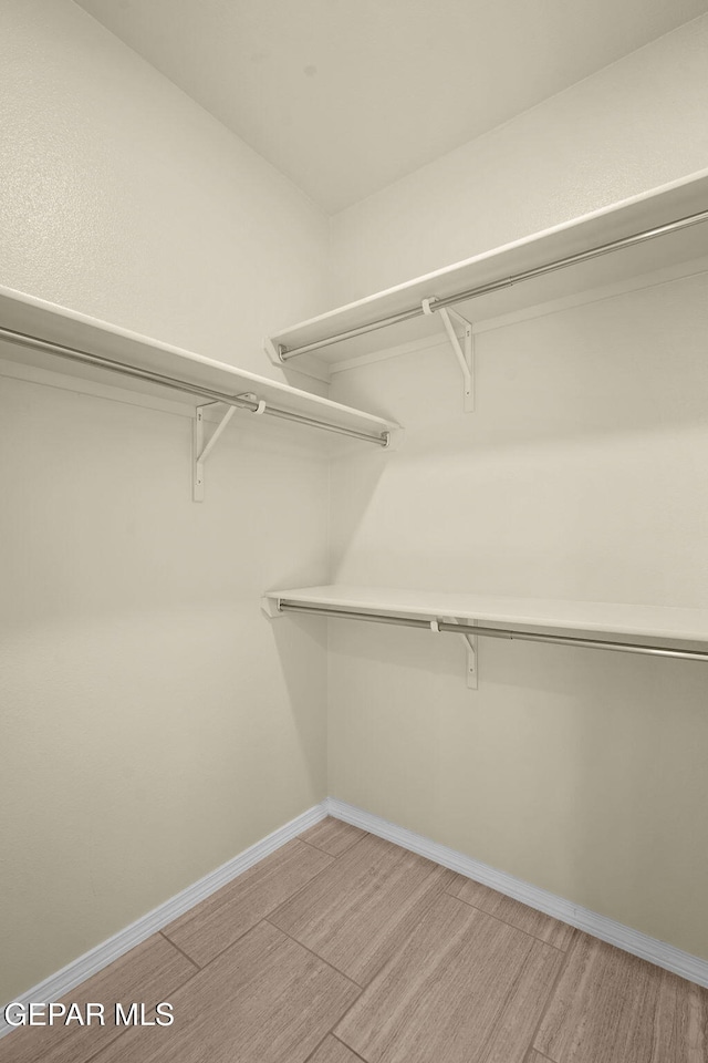 spacious closet with light wood-style flooring