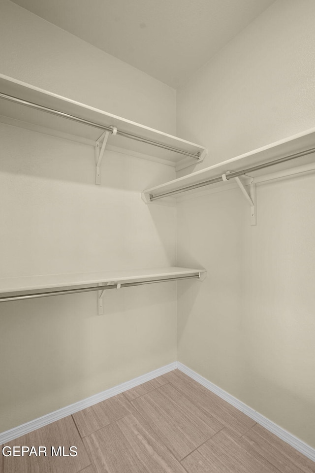 walk in closet featuring light wood finished floors