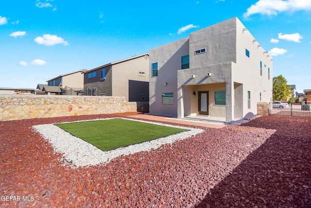 back of house featuring stucco siding, a fenced backyard, and a patio area