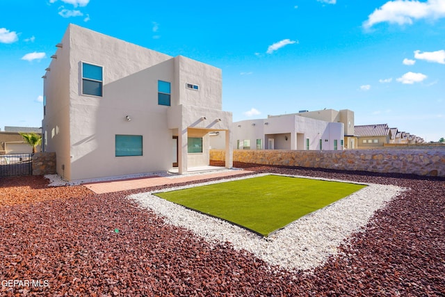 back of house featuring a patio area, a residential view, stucco siding, and a fenced backyard