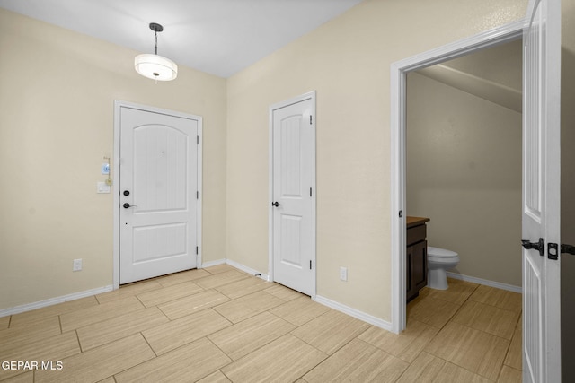 foyer featuring wood finish floors and baseboards